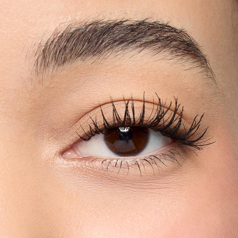 Close up shot of model with medium skintone showing eyelashes after Mary Kay Great Heights Mascara application