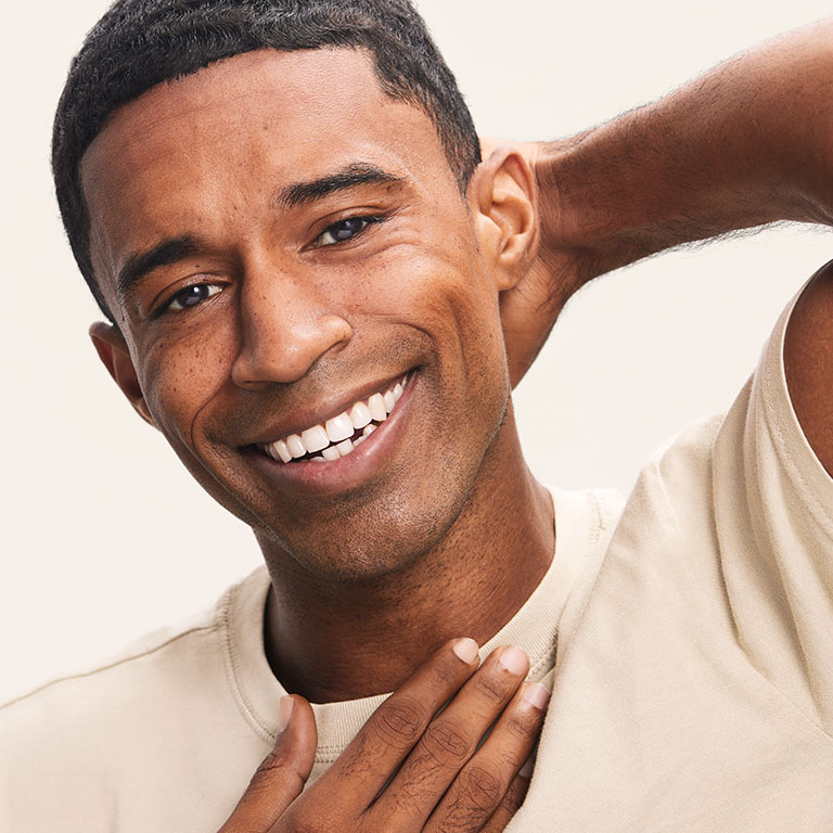 Man smiling at the camera after a clean shave