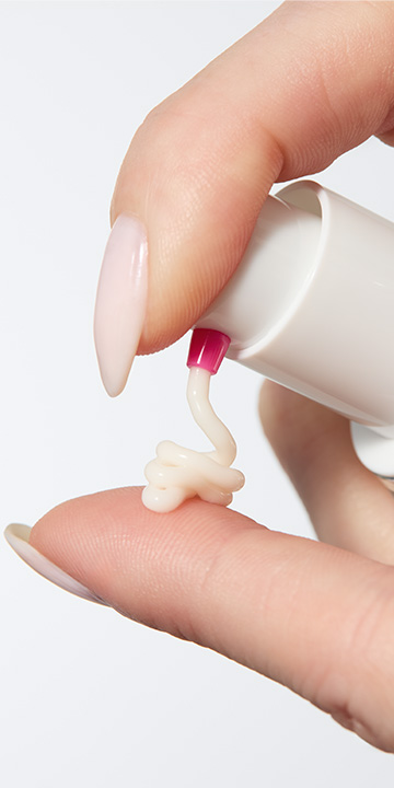 Hand pumping Mary Kay Clinical Solutions Barrier Restore 1:1:3 onto finger